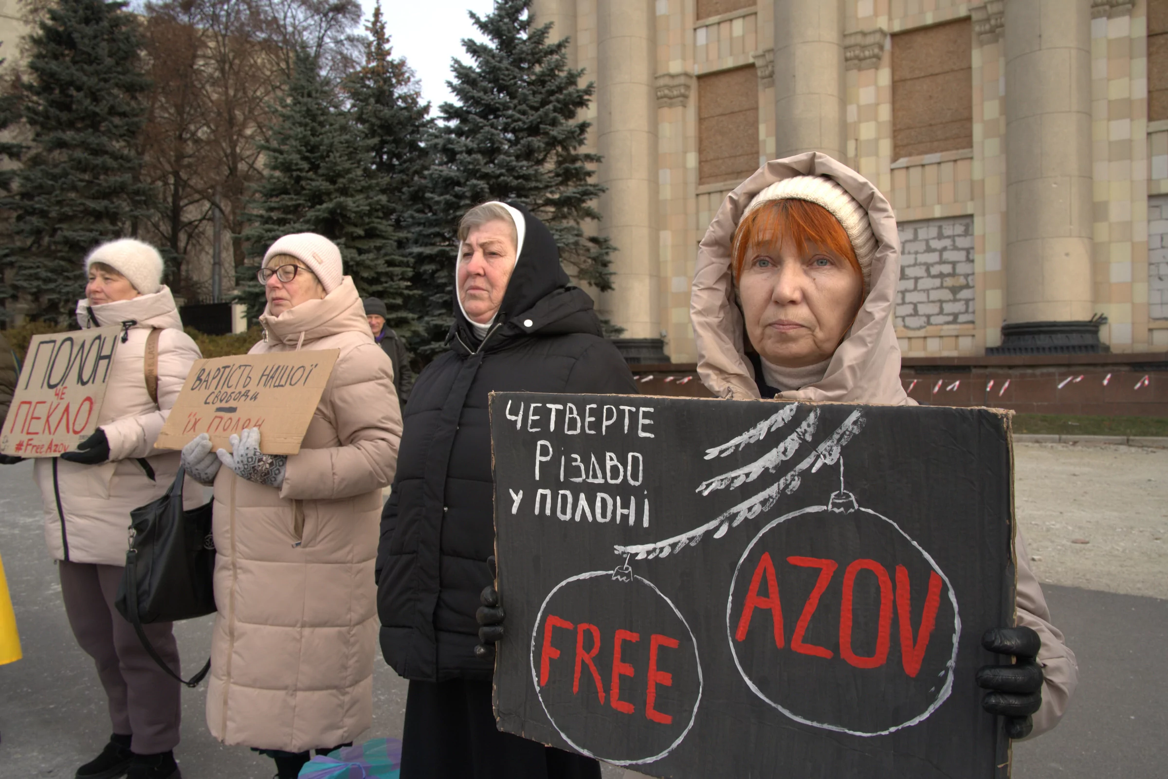 Женщины держат плакаты: Четвёртое Рождество в плену, Цена нашей свободы – их плен, Плен – это ад