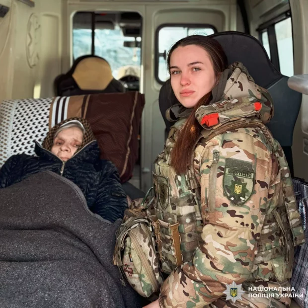 Полицейский спецподразделения «Белые Ангелы» помогает эвакуировать лежачую женщину